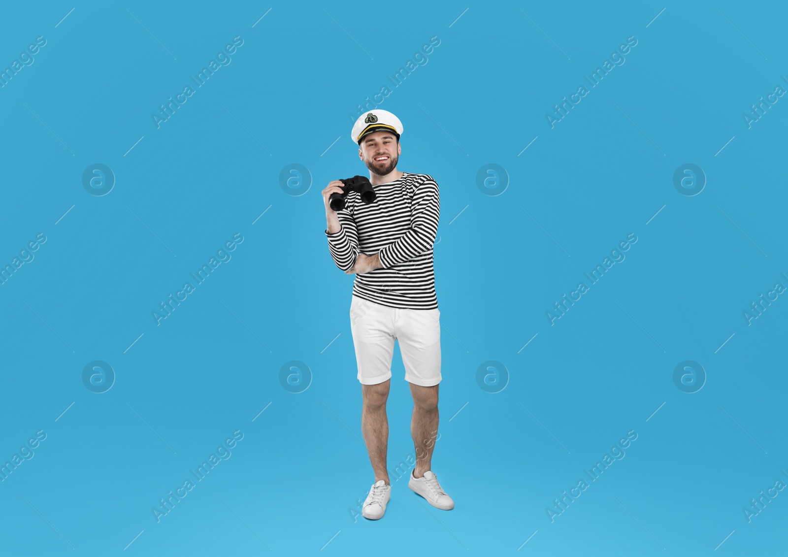 Photo of Sailor with binoculars on light blue background