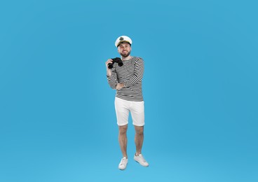 Photo of Sailor with binoculars on light blue background