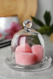 Photo of Glass cloche with delicious mochi on grey table. Traditional Japanese dessert