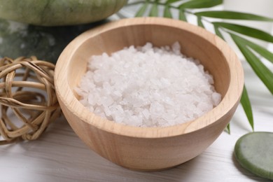 Photo of Beautiful spa composition with sea salt on white wooden table, closeup