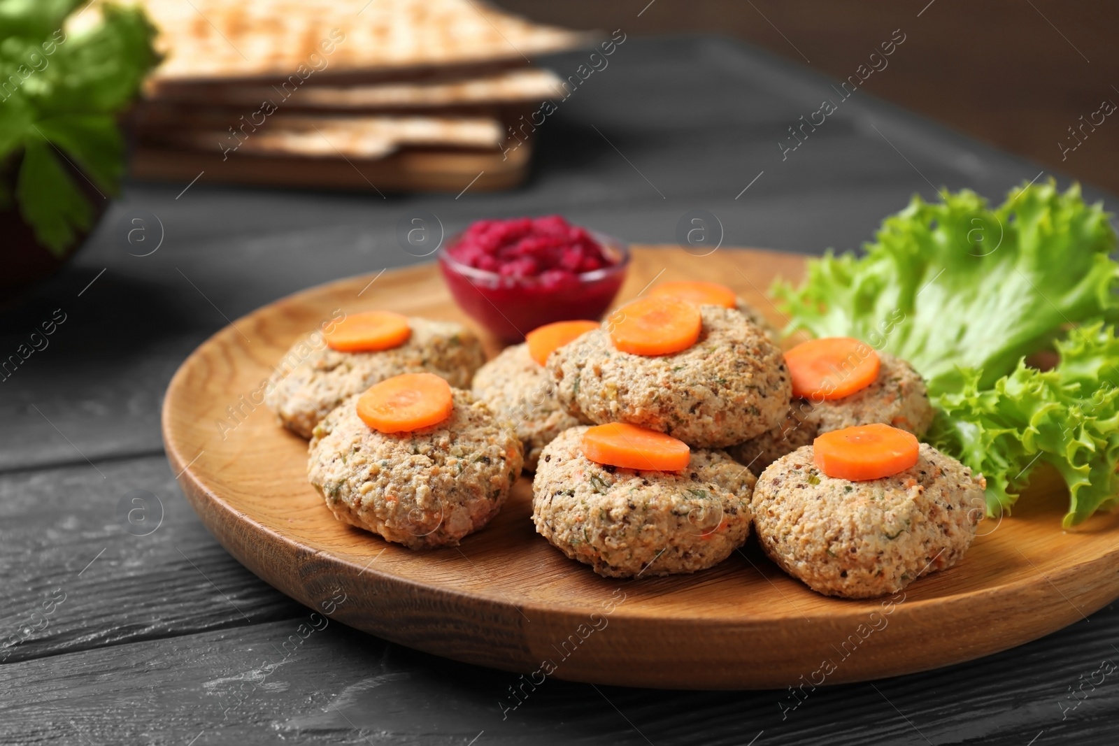 Photo of Plate of traditional Passover (Pesach) gefilte fish on wooden table, closeup