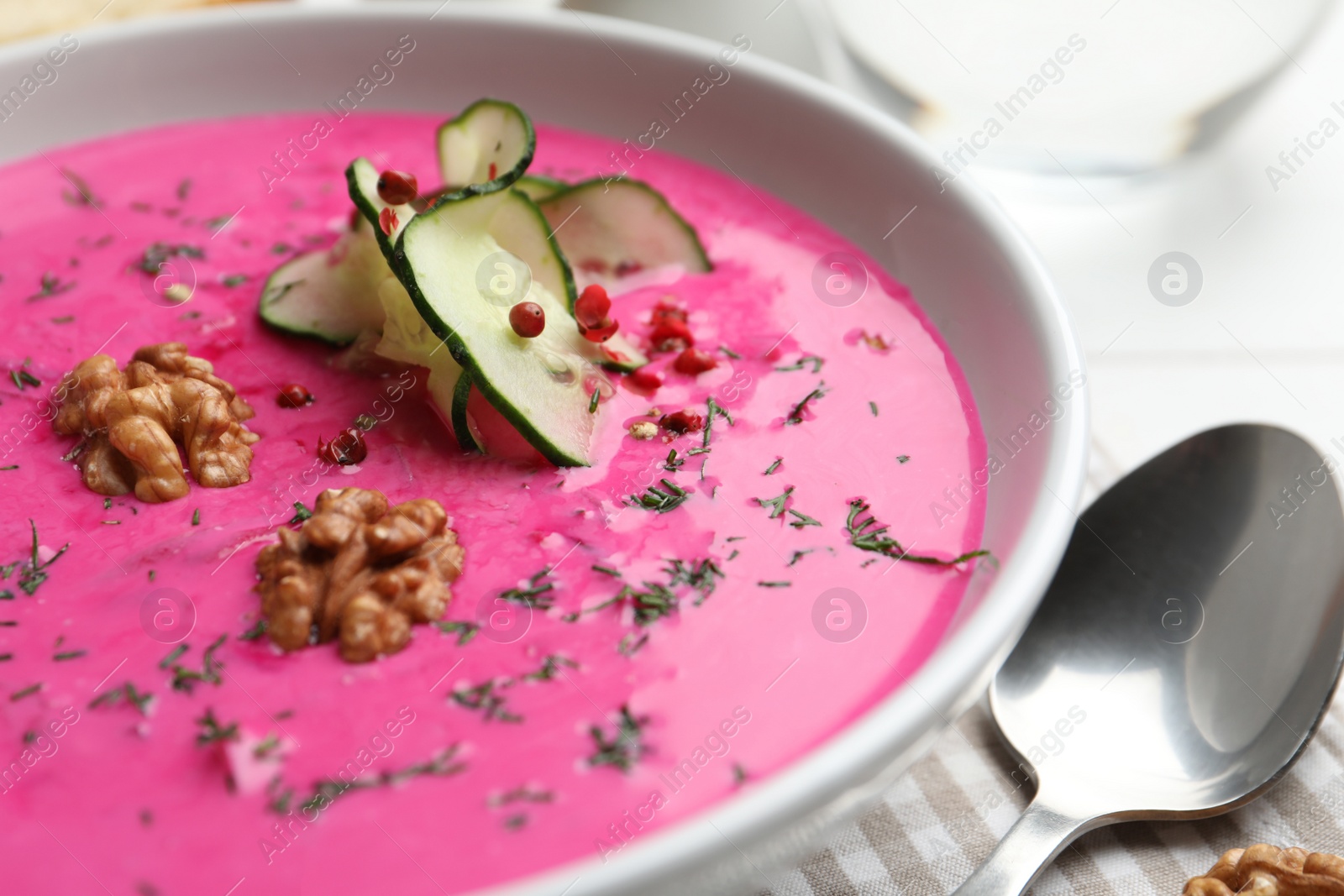 Photo of Delicious cold summer beet soup in bowl, closeup