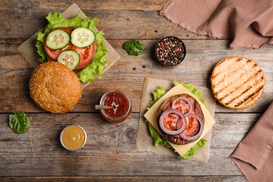 Flat lay composition with ingredients for burger on wooden table