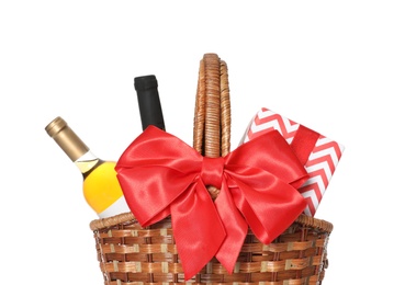 Festive basket with bottles of wine and gift on white background