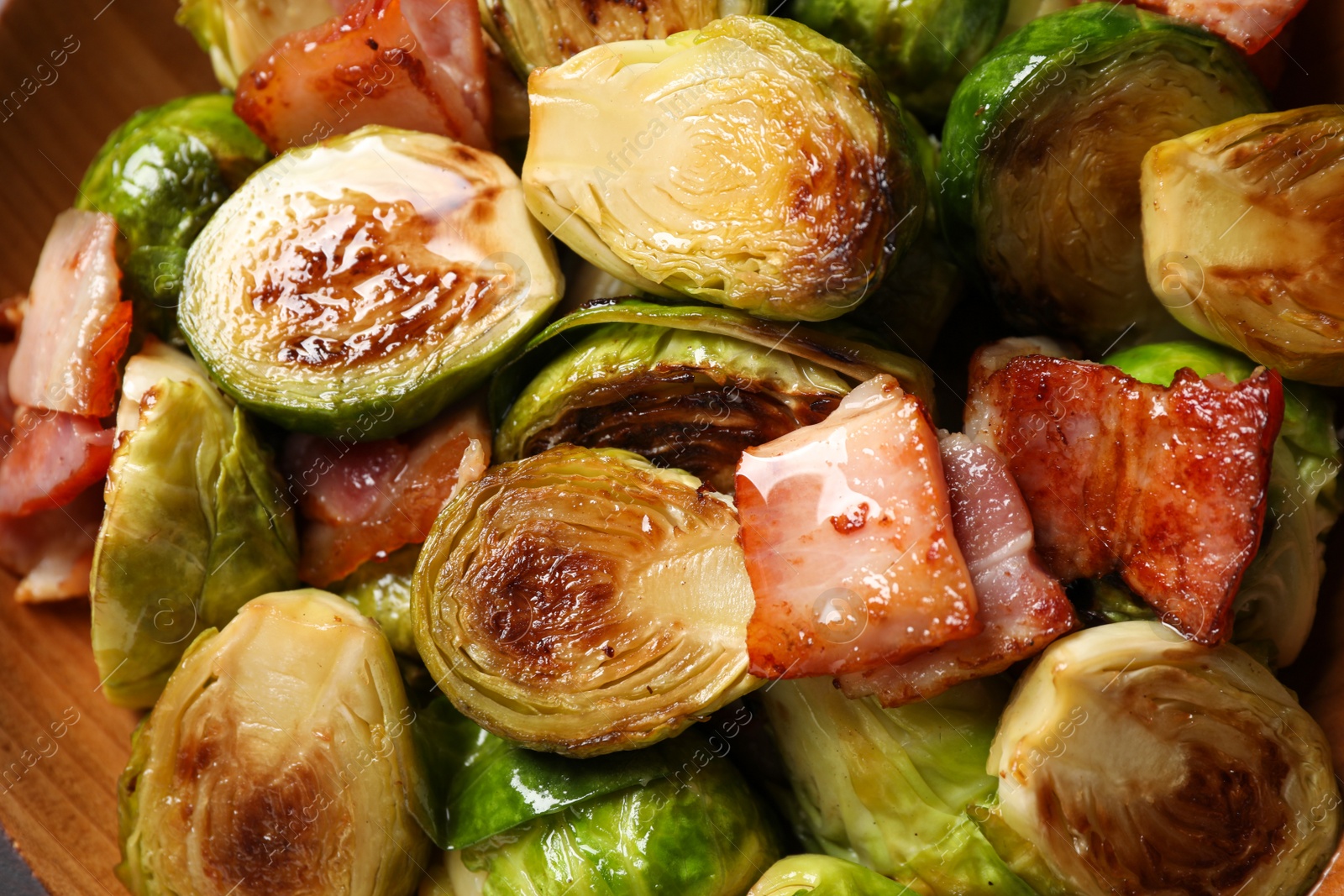 Image of Delicious fried Brussels sprouts with bacon in bowl, closeup