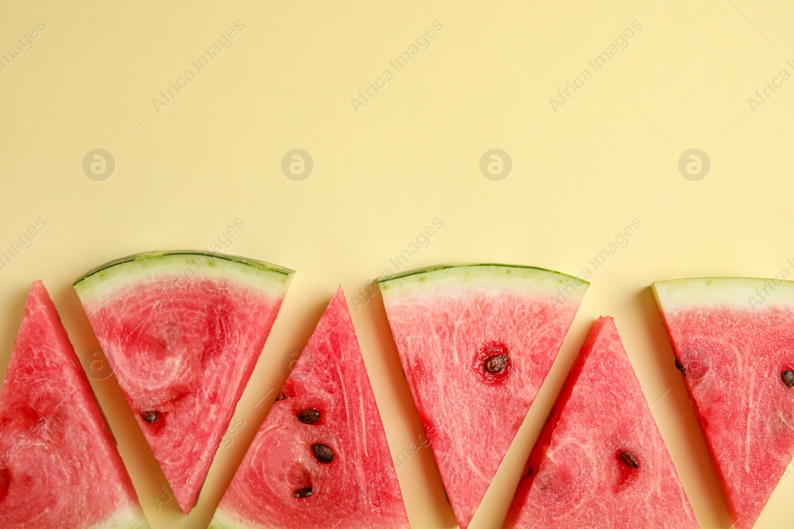 Photo of Slices of ripe watermelon on beige background, flat lay. Space for text