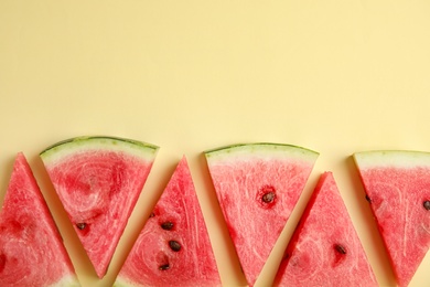 Slices of ripe watermelon on beige background, flat lay. Space for text