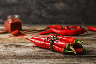 Photo of Bunch of red chili peppers on wooden table