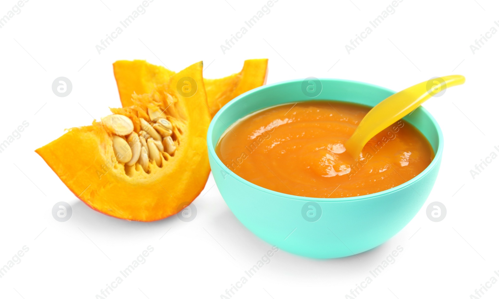 Photo of Bowl of healthy baby food and pumpkin slices on white background