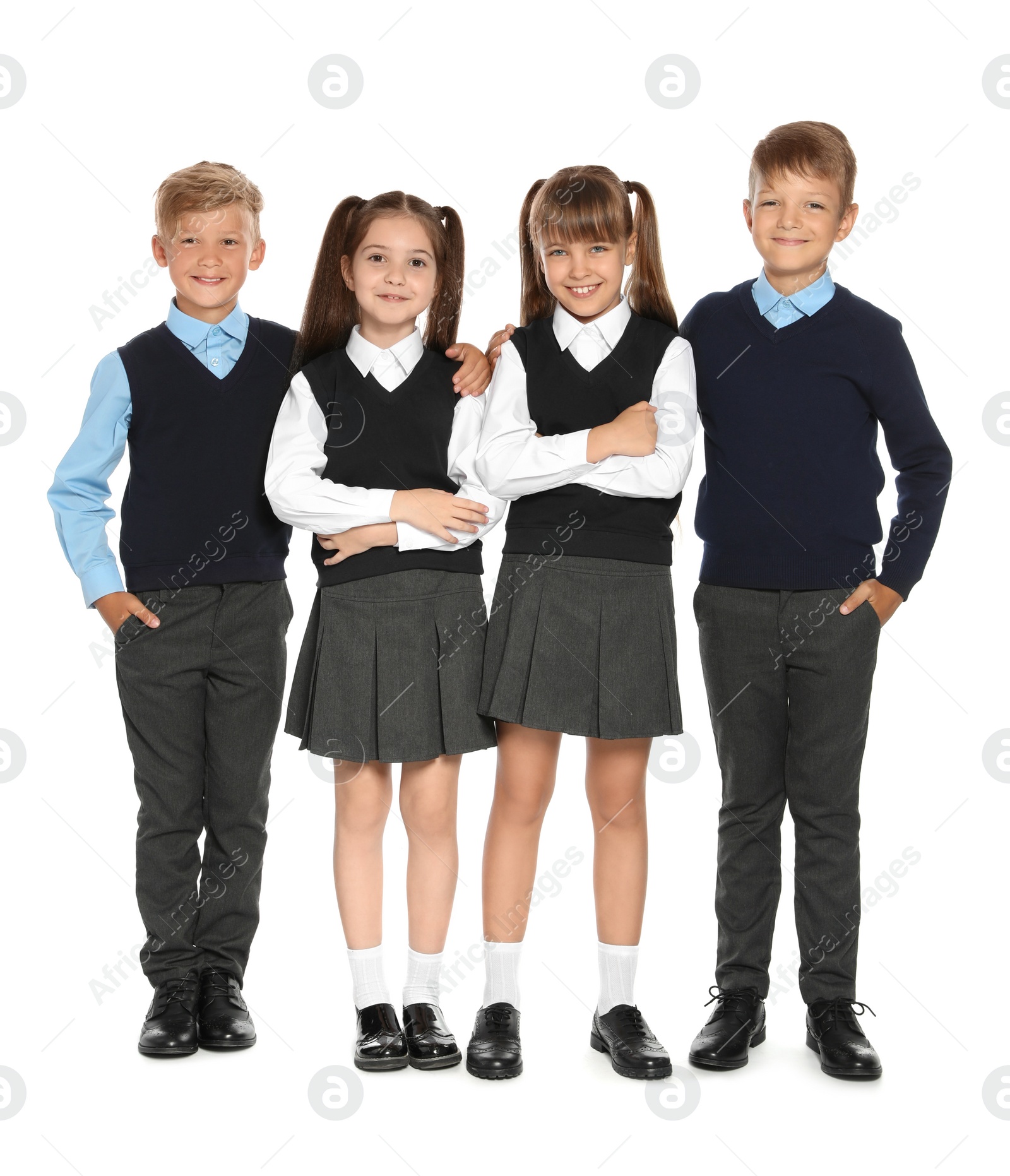 Photo of Little children in stylish school uniform on white background