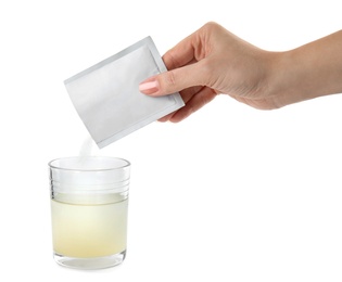 Photo of Woman pouring powder from medicine sachet into glass of water on white background, closeup