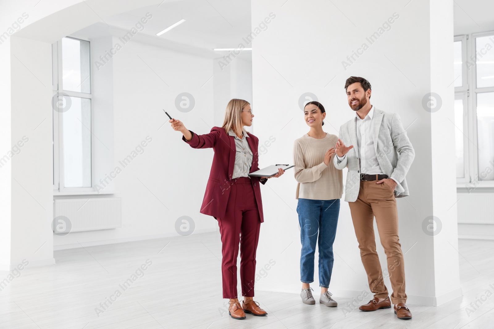 Photo of Real estate agent showing new apartment to couple