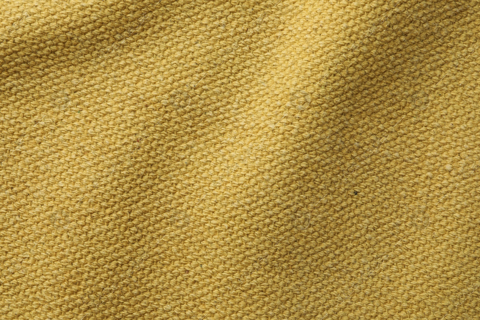 Photo of Texture of golden color fabric as background, top view