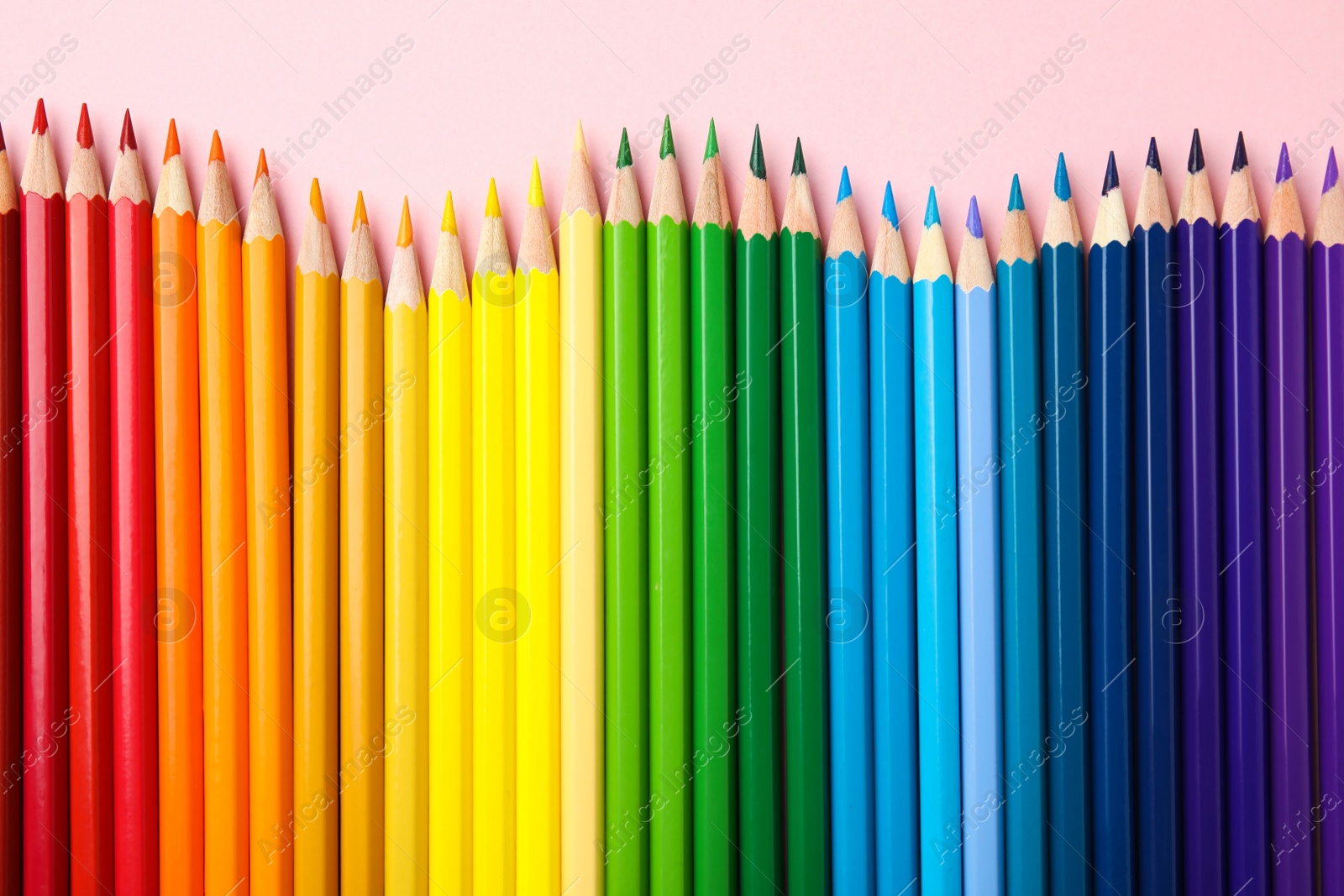 Photo of Flat lay composition with color pencils on pink background