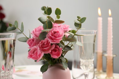 Photo of Romantic dinner. Bouquet with beautiful pink roses on table