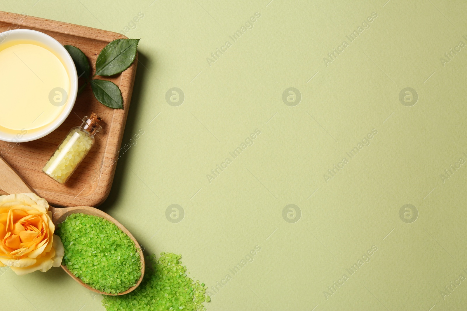 Photo of Flat lay composition with aromatic sea salt and beautiful flower on pale green background. Space for text