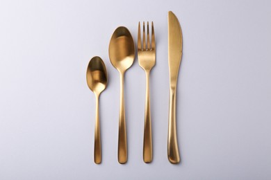 Photo of Stylish cutlery set on grey table, flat lay