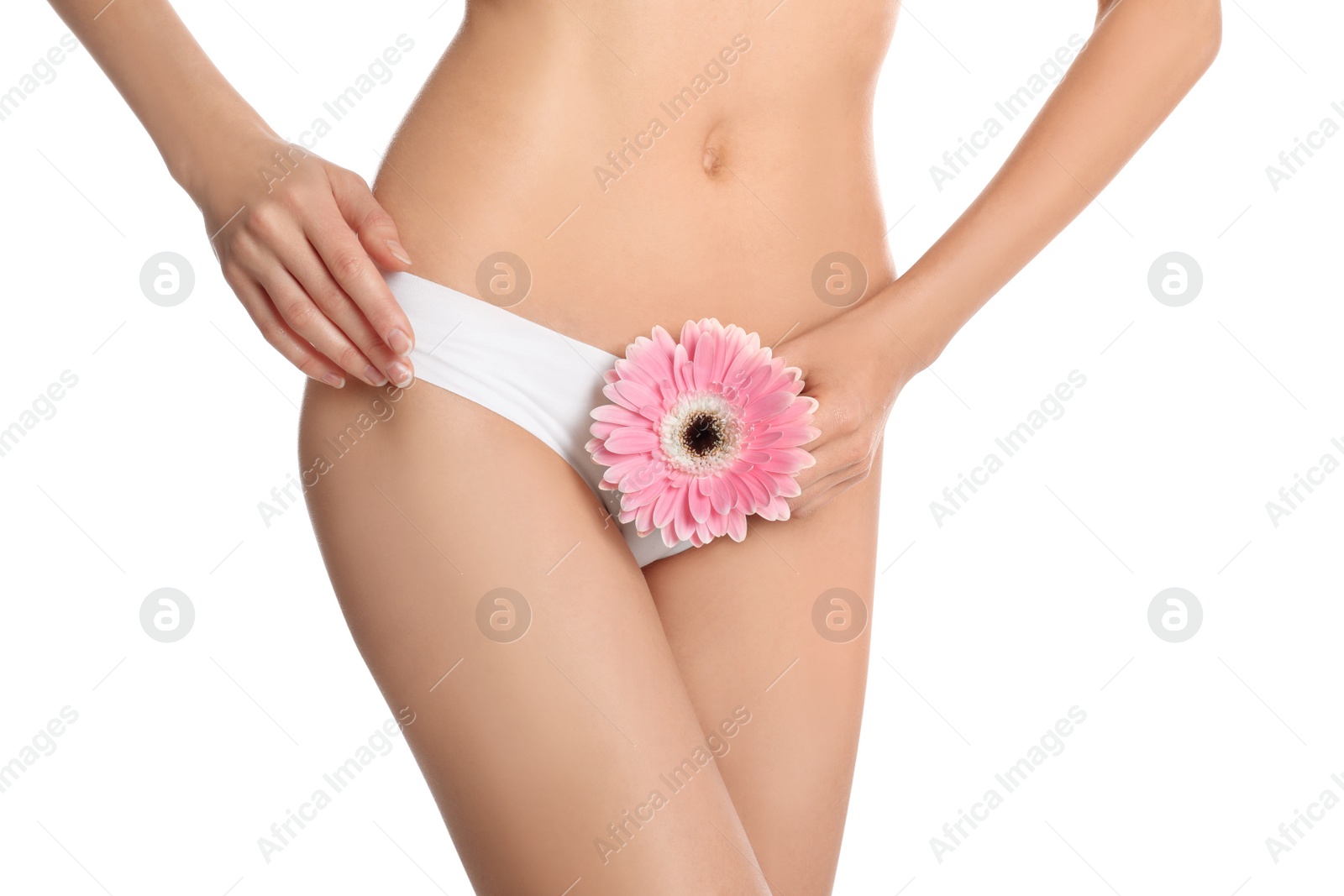 Photo of Woman with flower showing smooth skin after bikini epilation on white background, closeup. Body care concept