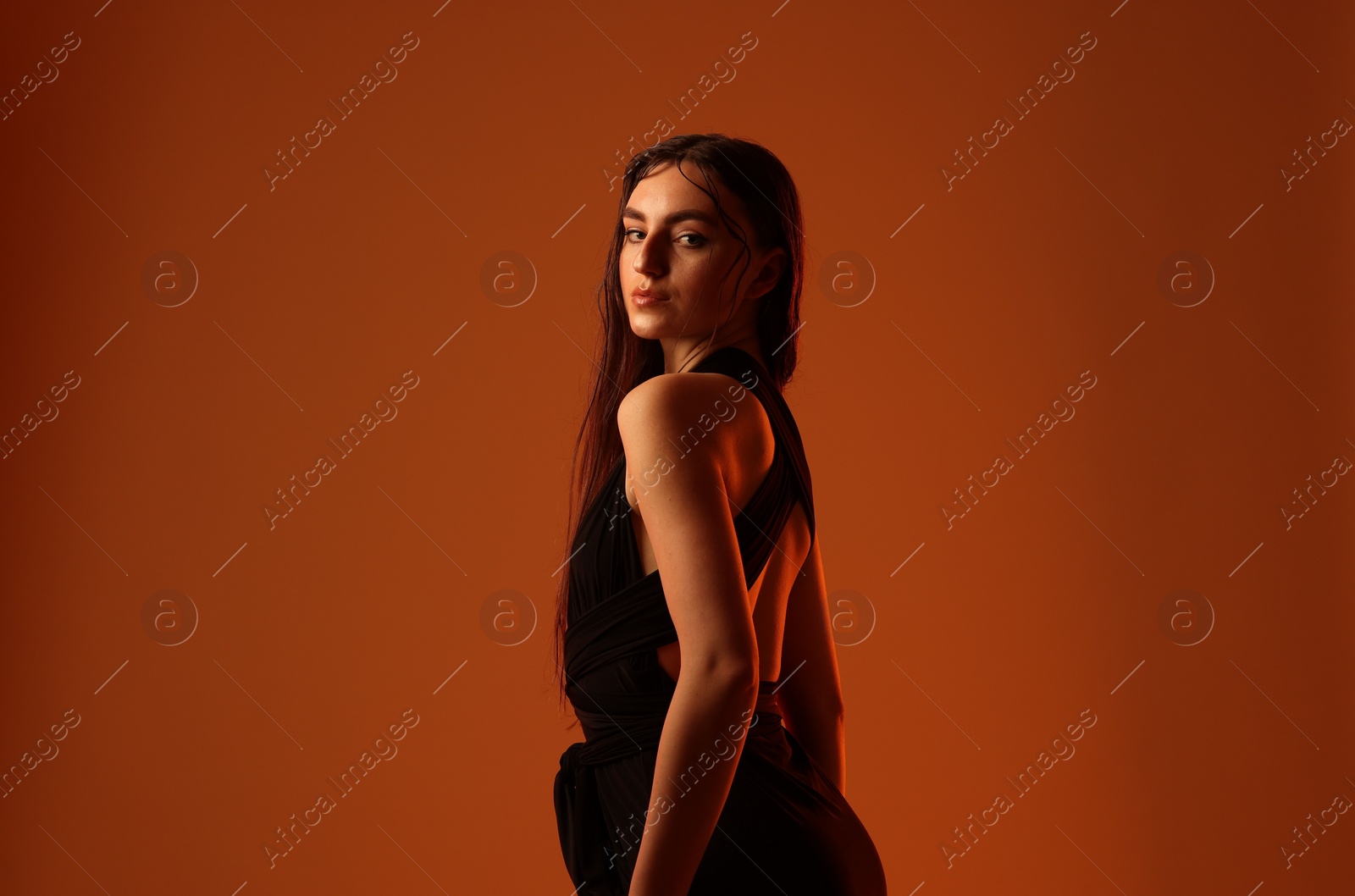 Photo of Portrait of beautiful woman on brown background