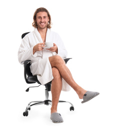 Photo of Young man in bathrobe with cup of drink on white background