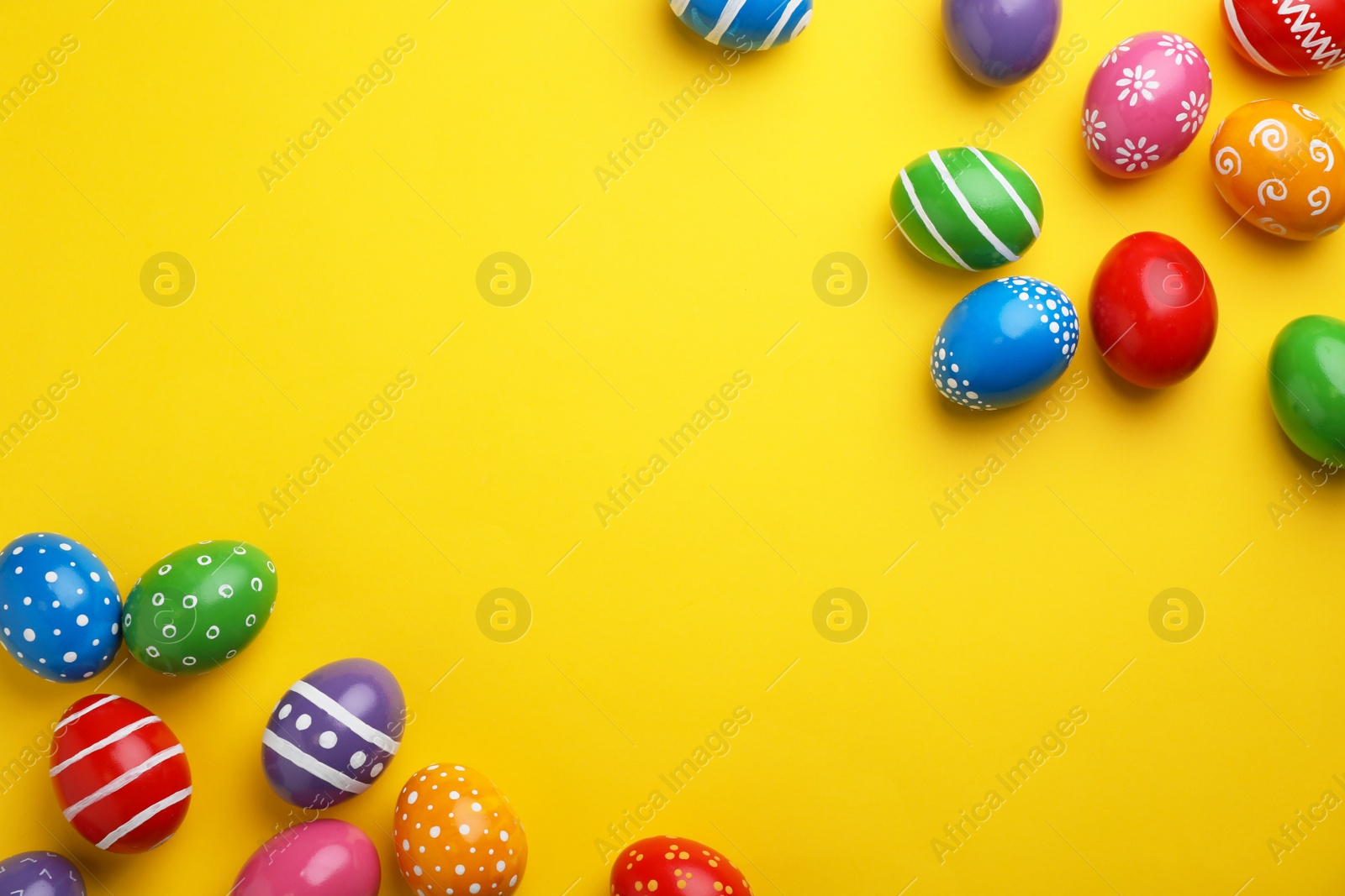 Photo of Decorated Easter eggs and space for text on color background, top view