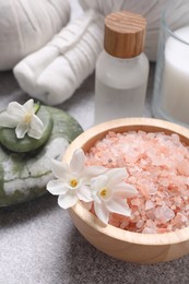 Photo of Spa composition with sea salt and flowers on light grey table