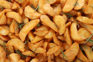 Photo of Baked potatoes with rosemary as background, top view