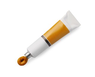 Photo of Tube with oil paint on white background, top view