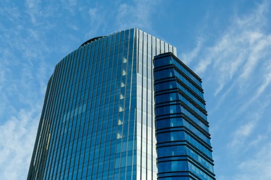 Exterior of beautiful skyscraper against cloudy sky, low angle view