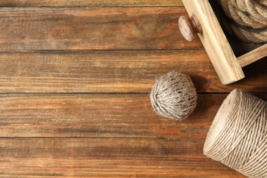 Photo of Flat lay composition with natural hemp ropes and space for text on wooden background