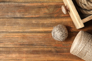 Flat lay composition with natural hemp ropes and space for text on wooden background