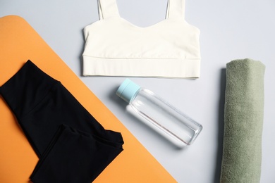 Photo of Flat lay composition with yoga equipment on grey background