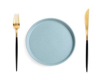 Empty plate with golden fork and knife on white background, top view