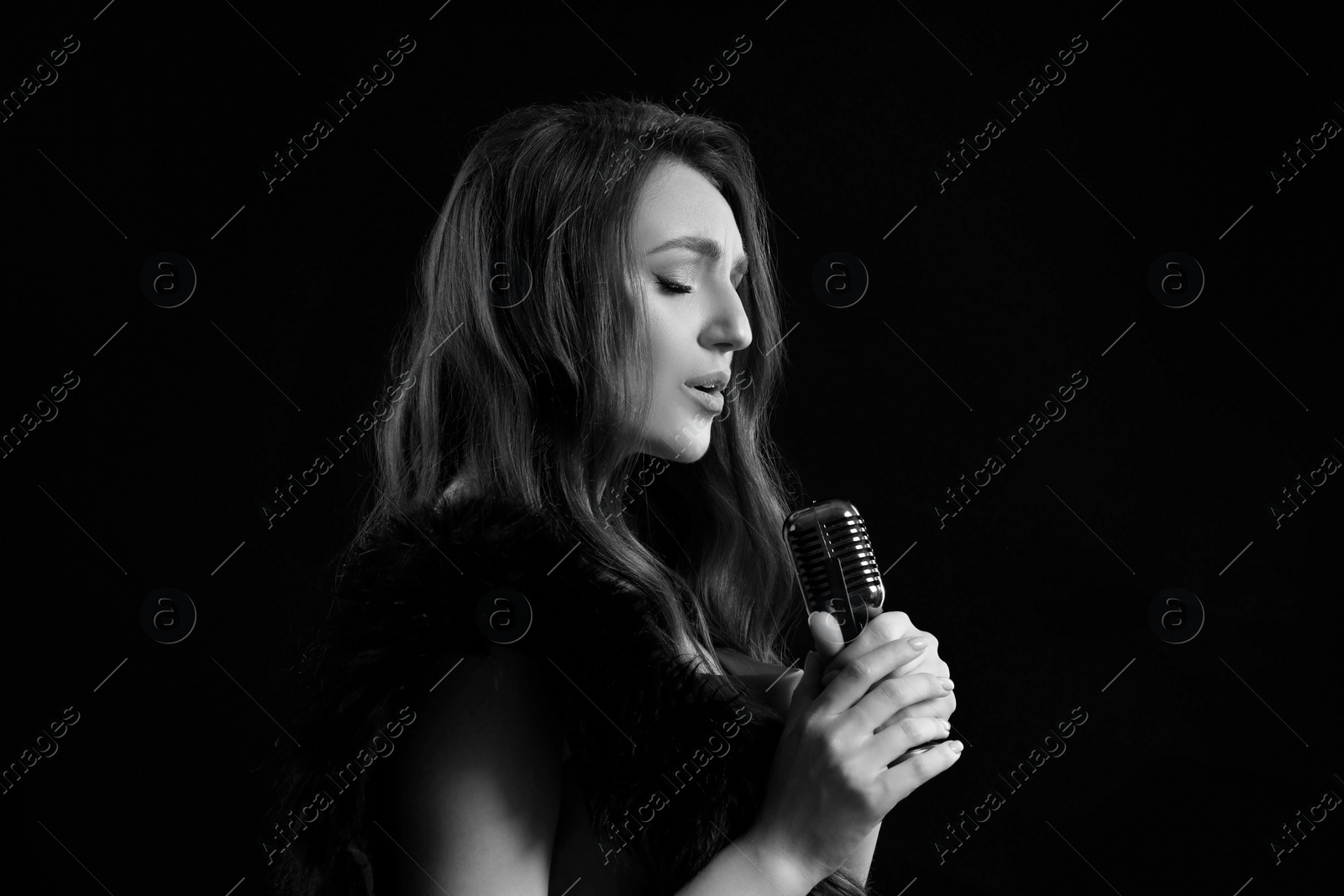 Image of Beautiful singer with microphone, black and white effect