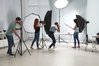 Photo studio with professional equipment and team of workers