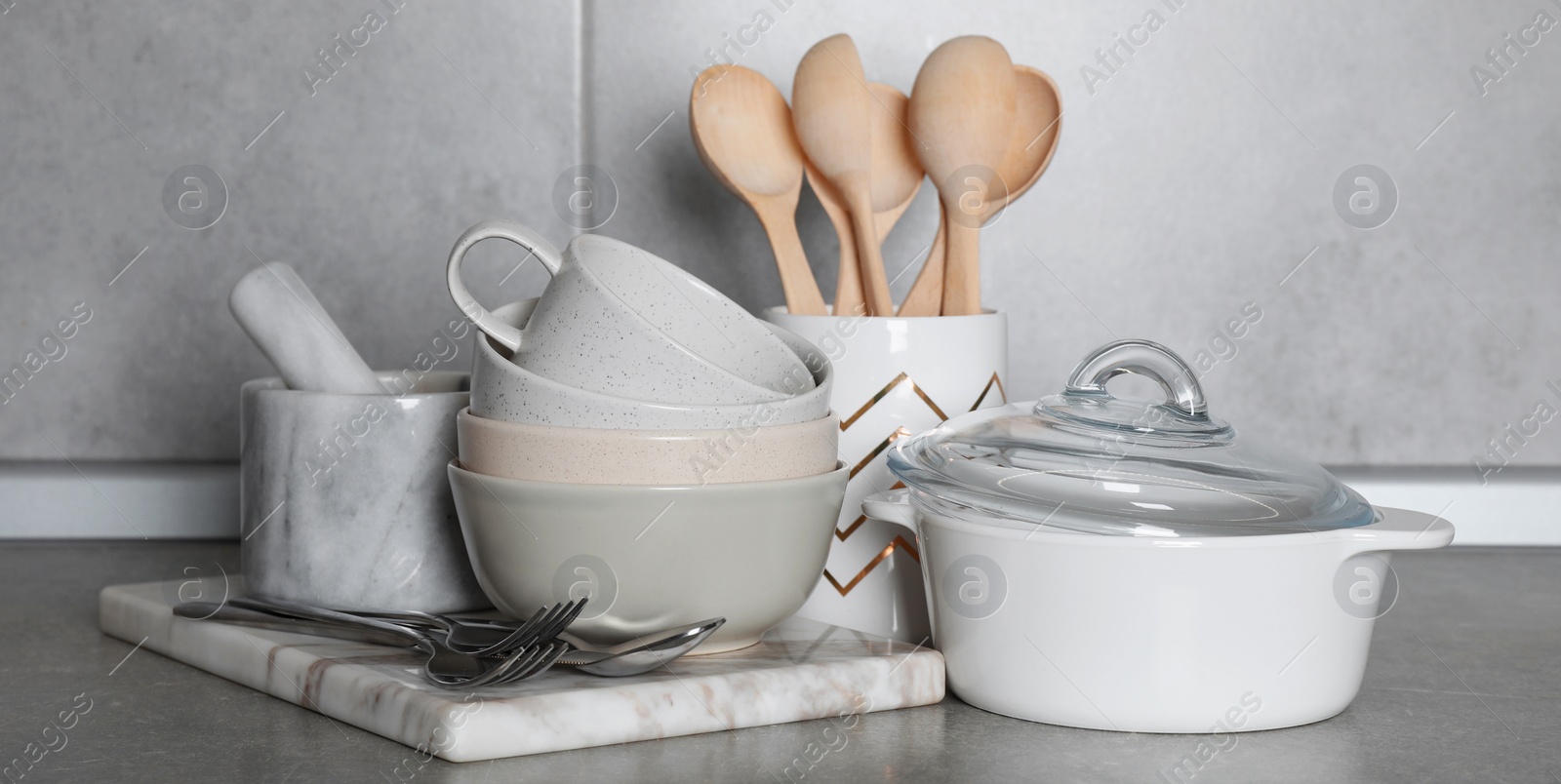 Image of Set of cooking utensils and cookware on grey countertop in kitchen. Banner design