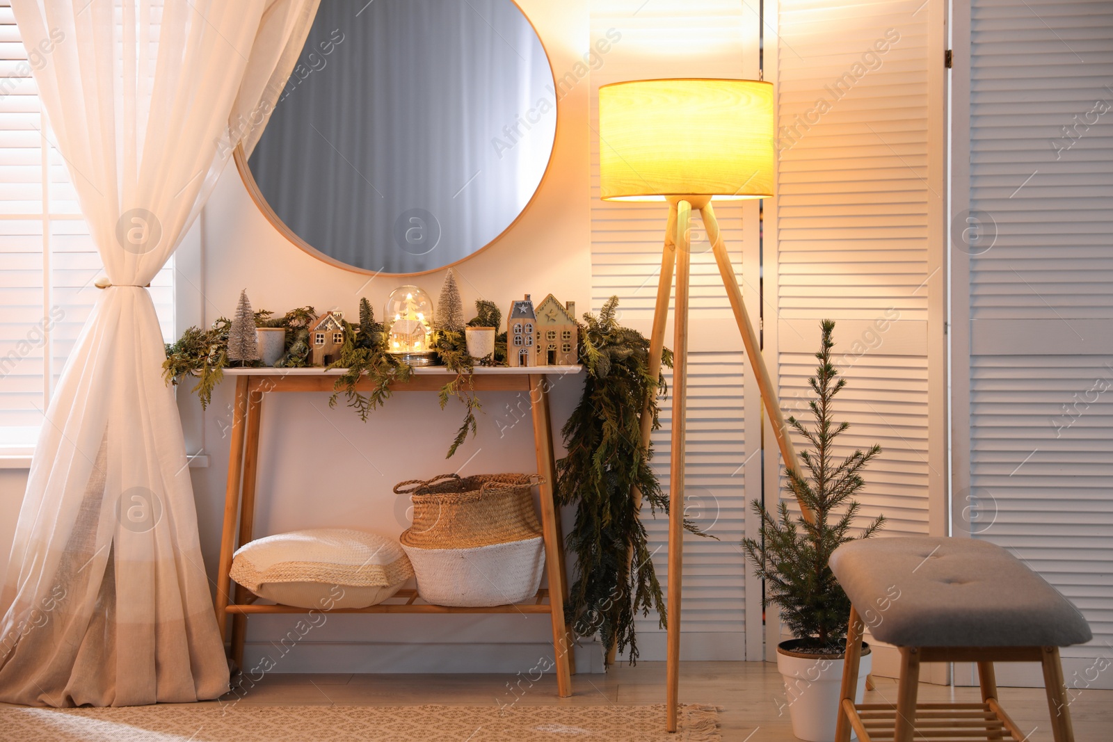 Photo of Stylish room interior with mirror and wooden console table near wall