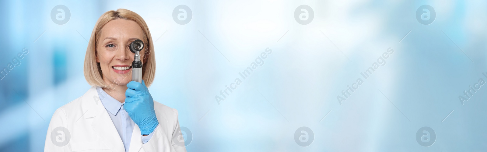 Image of Professional dermatologist with dermatoscope on blurred background, space for text. Banner design