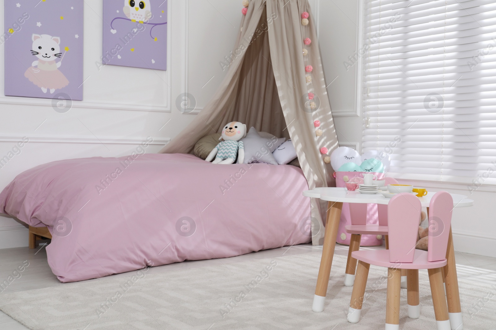 Photo of Cute child's room interior with toys and modern furniture