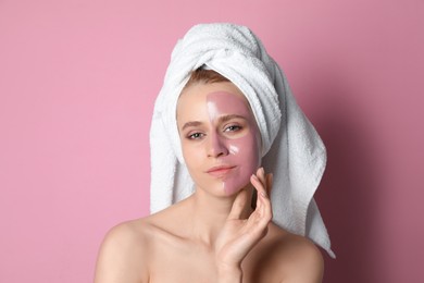 Photo of Young woman with pomegranate face mask on pink background