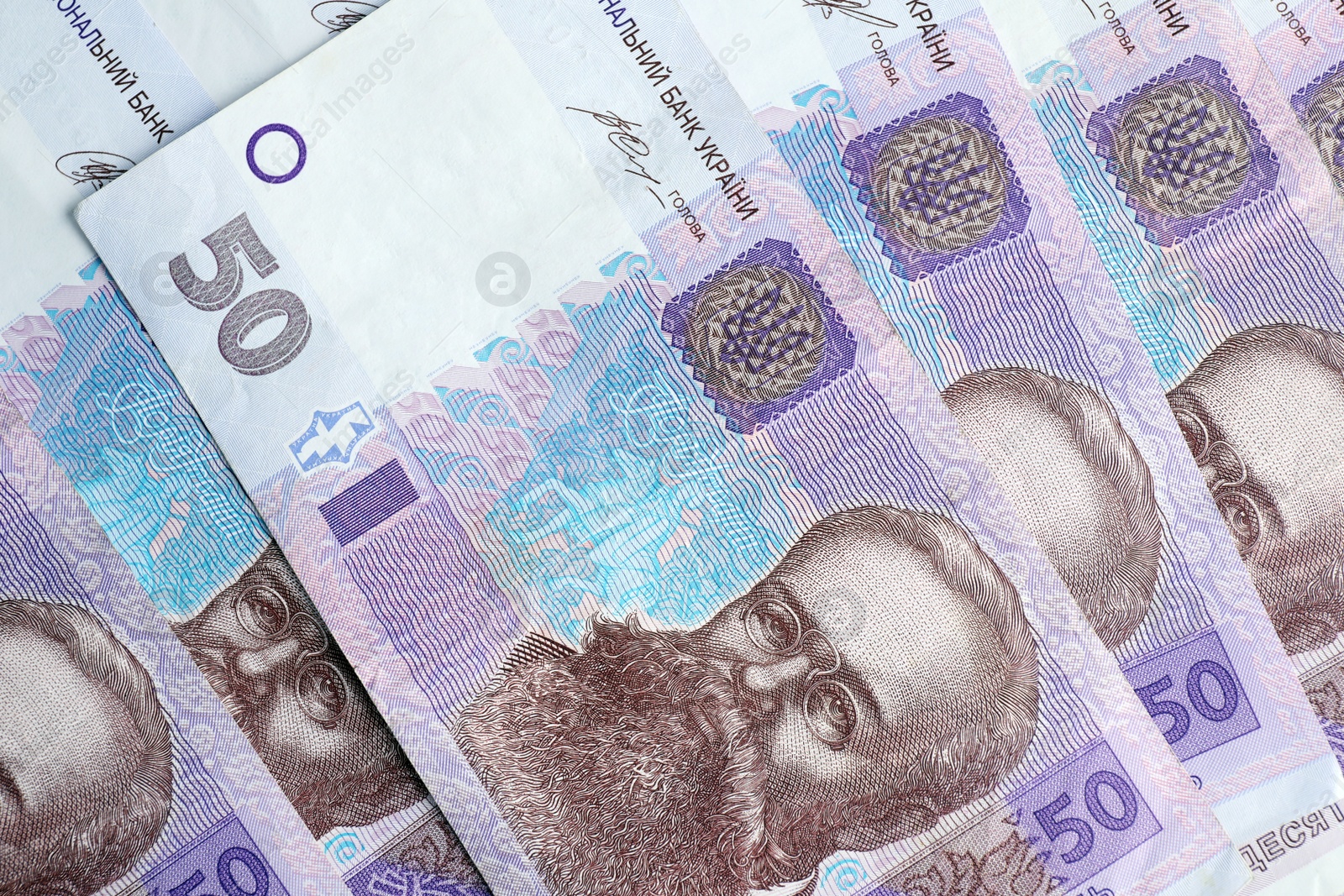 Photo of Closeup view of Ukrainian money as background. National currency