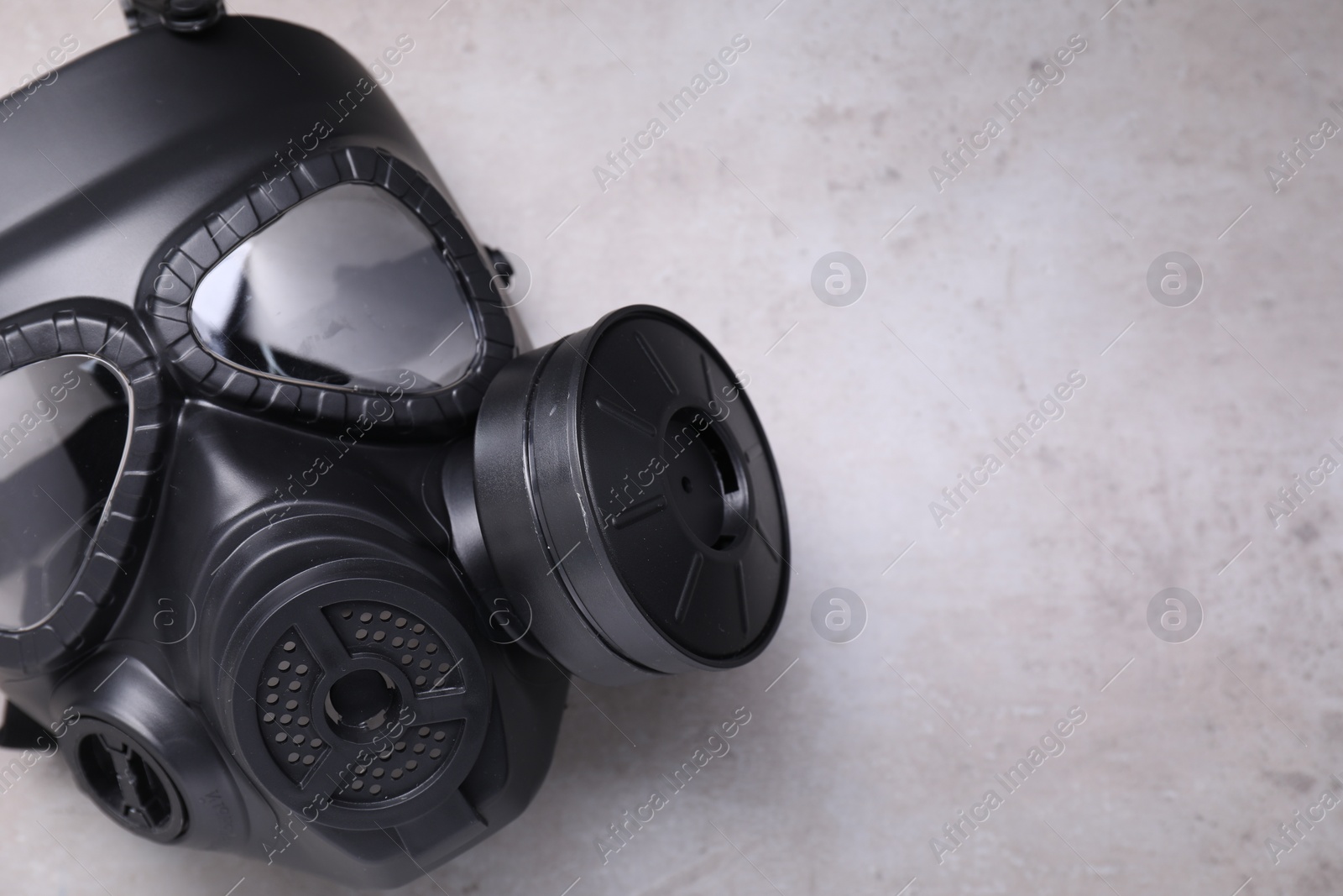 Photo of One gas mask on grey textured background, top view. Space for text