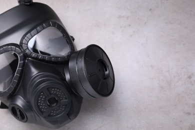 One gas mask on grey textured background, top view. Space for text