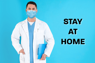 Doctor in medical mask and text STAY AT HOME on light blue background