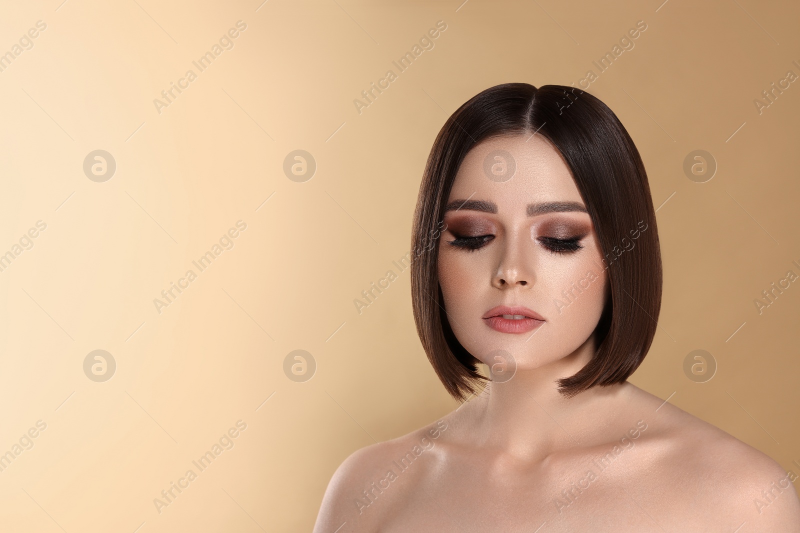 Image of Portrait of pretty young woman with brown hair on beige background, space for text