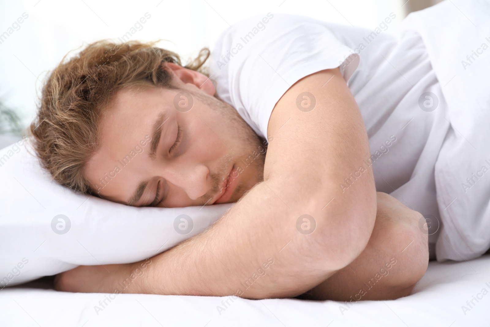 Photo of Handsome young man sleeping on pillow at home. Bedtime