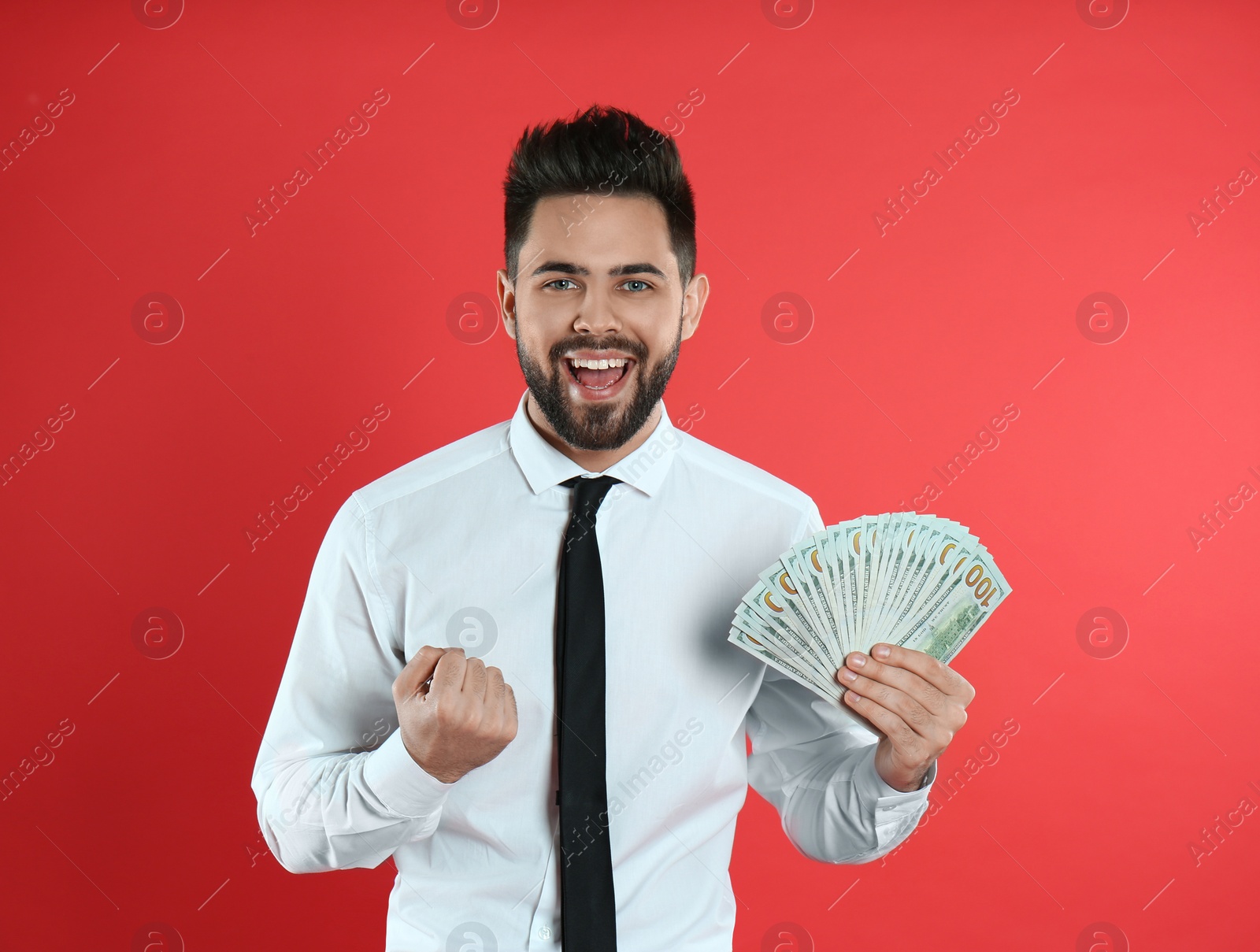 Photo of Emotional young man with money on crimson background. Space for text