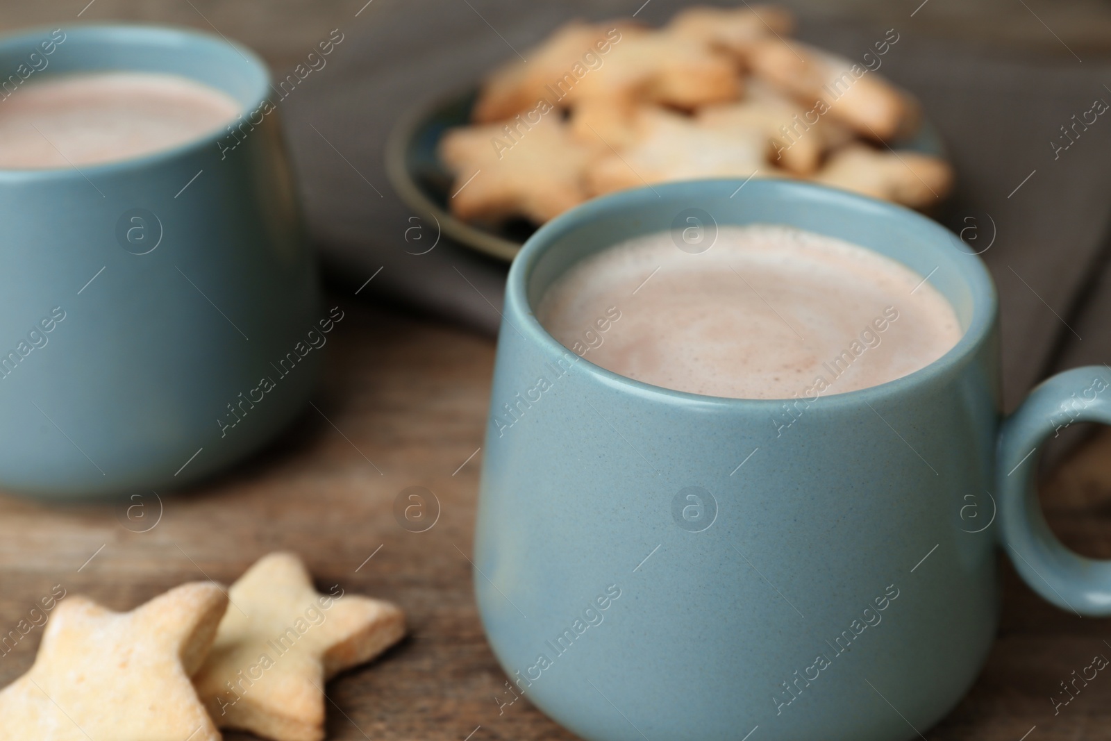 Photo of Composition with delicious hot cocoa drink and cookies on wooden table, closeup