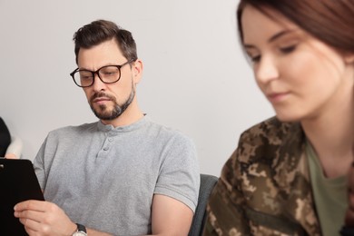 Psychologist working with female military officer in office