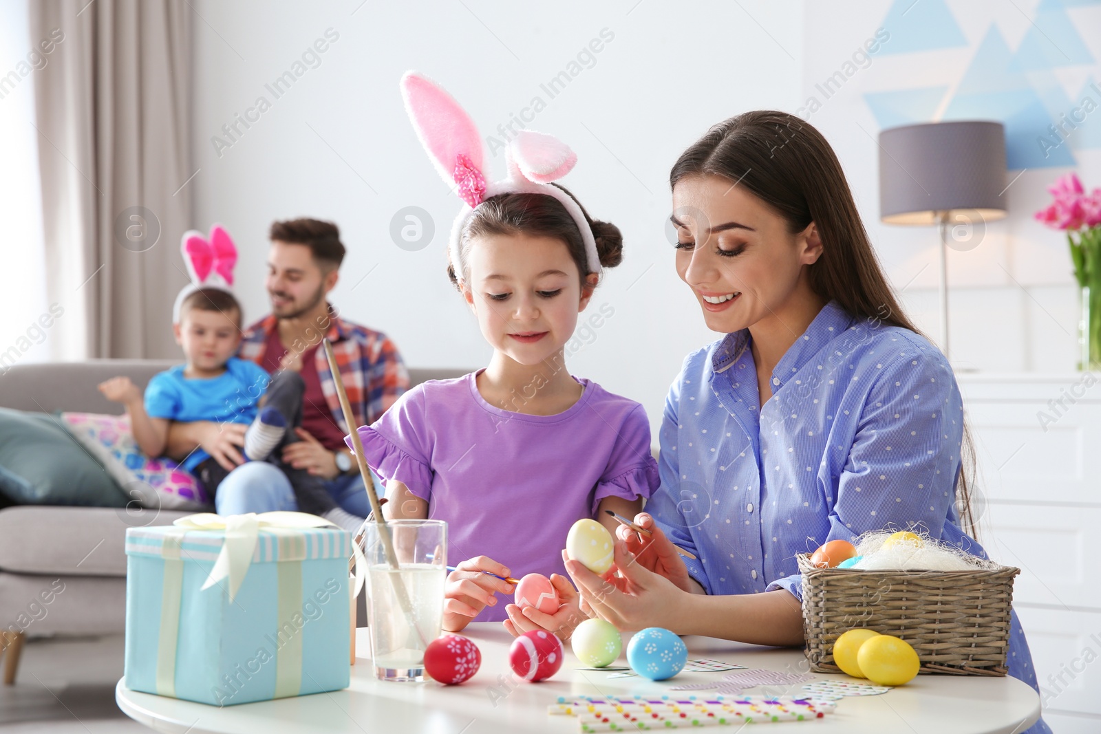 Photo of Happy family preparing for Easter holiday at home